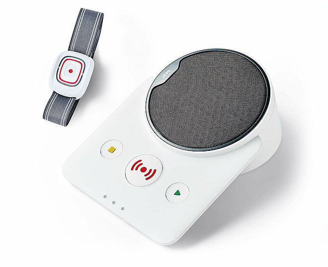 Das Hausnotrufgerät besteht aus einer Basisstation und einem Funksender mit Notrufknopf, den Sie am Arm tragen.